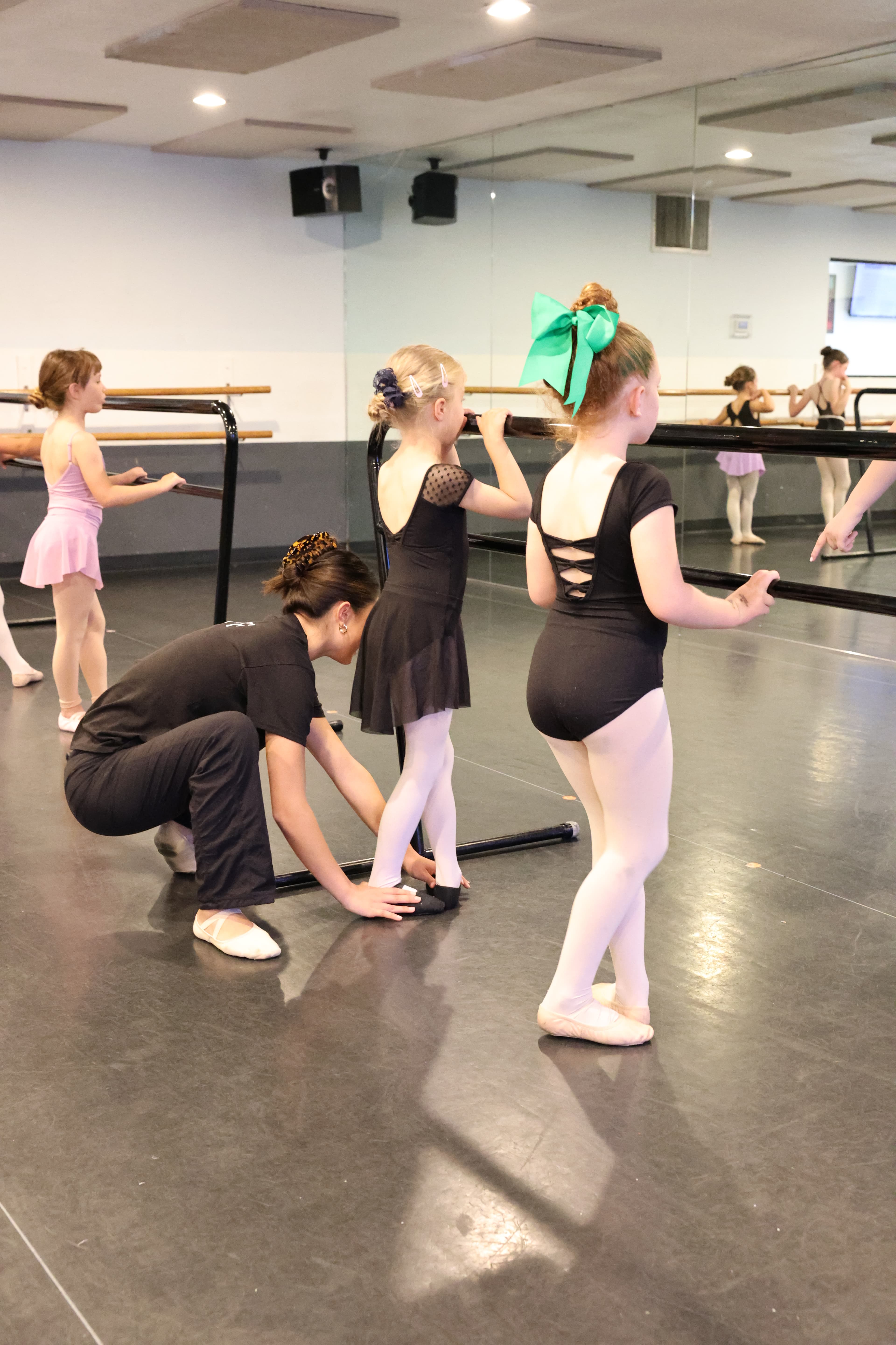 Students and instructors working together in a ballet studio