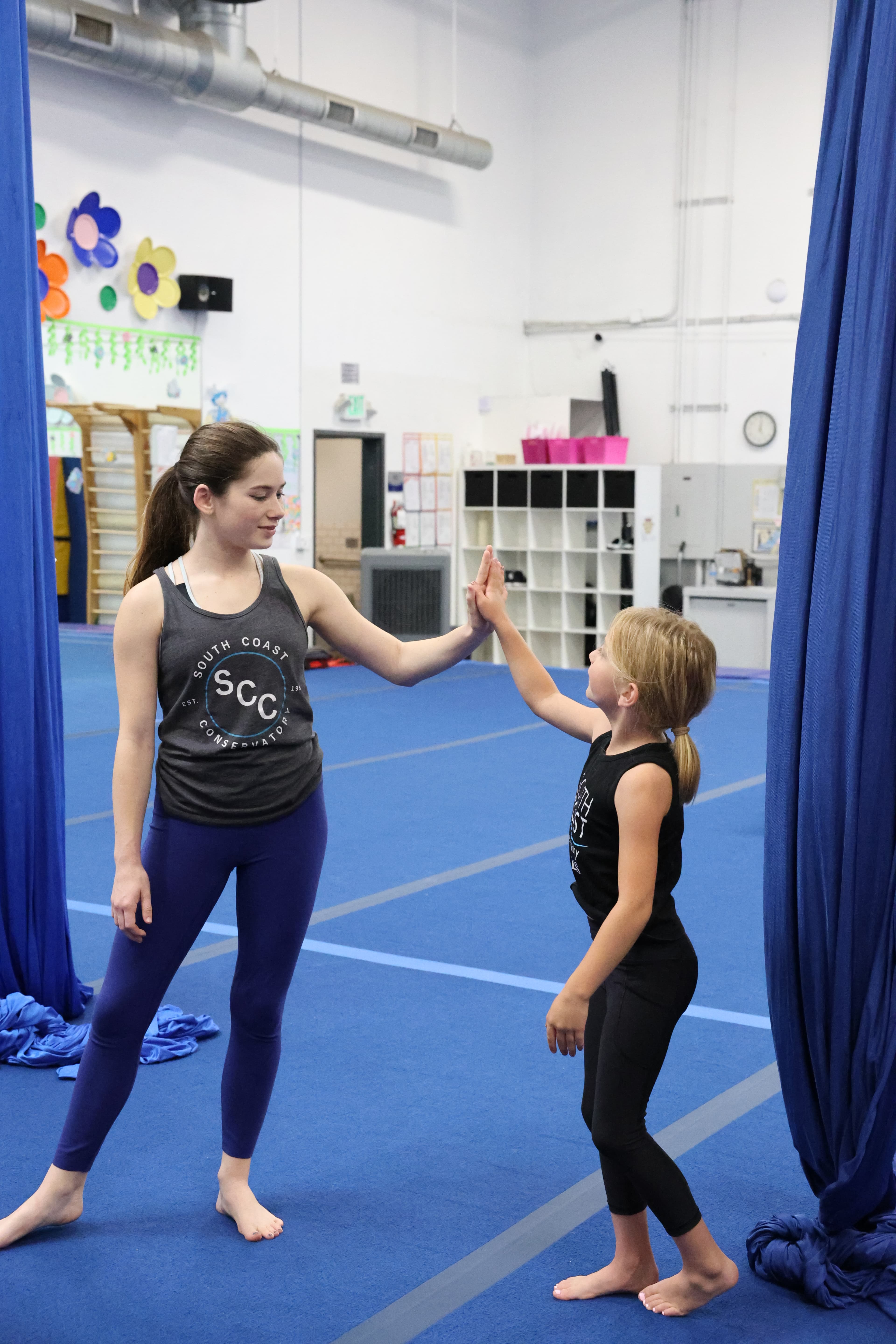 Instructor giving a young student a high five after class