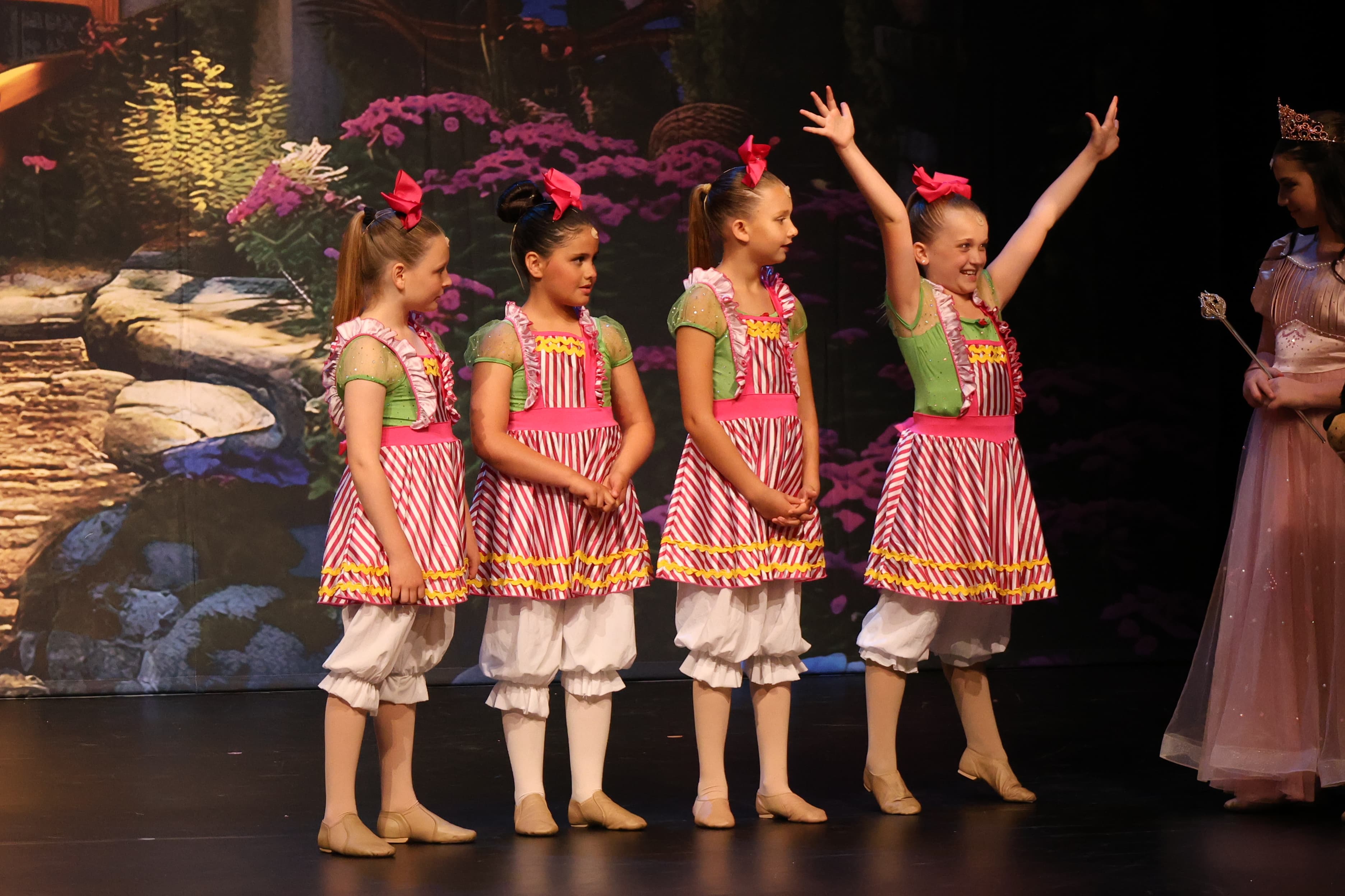 Young dancers lined up on stage during a recital